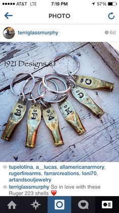 a bunch of keys that are on top of a wooden table with words written in them