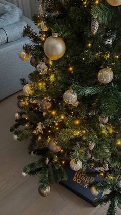 a christmas tree with gold and white ornaments