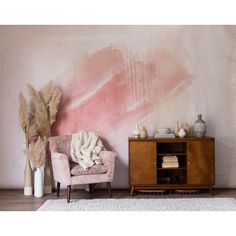 a living room with pink paint on the wall and two chairs in front of it