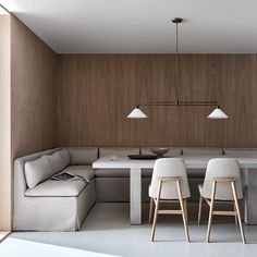 a living room and dining area are shown in this modern style house with wood paneling on the walls