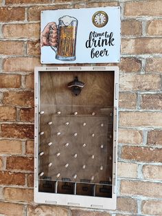 a brick wall with a beer sign hanging from it's side and a glass filled with liquid