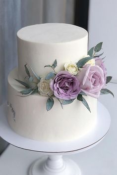 there is a white cake with flowers on it