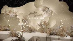 an image of a stage set up for a wedding ceremony with lights and snow on the ground