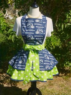 a mannequin wearing a green and blue dress with white polka dots on it