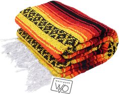 multicolored throw blankets stacked on top of each other with fringes around them