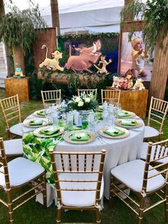 a table set up for a party with plates and napkins on it, surrounded by chairs