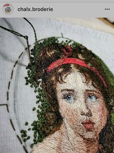 an embroidered picture of a woman's face with green leaves on her head and the words, chax broderie