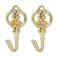 two pairs of gold tone earrings with an open heart and crown design on each ear