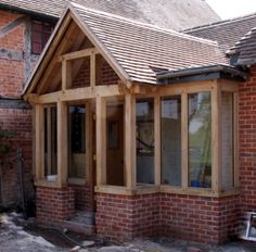 a brick house with wood framing and windows