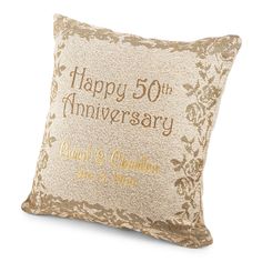 a pillow that says happy 50th anniversary with gold lettering on it and an embroidered design