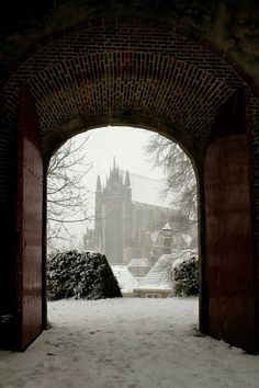 an archway leading to a castle in the snow