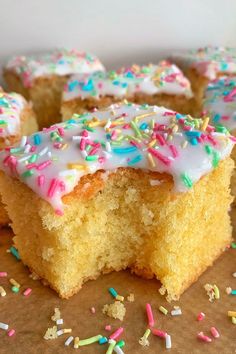 several pieces of cake with white frosting and sprinkles