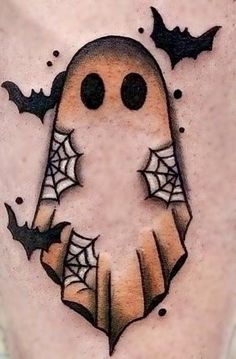 a tattoo with a ghost and bats on it