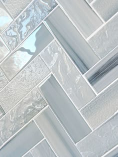 a close up view of a tile wall with white and gray squares on the bottom