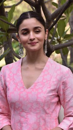 anusha bhatra in pink dress posing for the camera with her hands on her hips