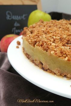 a piece of pie sitting on top of a white plate next to an apple slice