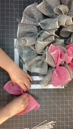 someone is working with fabric to make a wreath