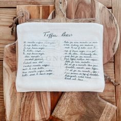 a piece of cloth with writing on it sitting on top of wooden boards and pieces of wood