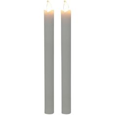 two white candles sitting next to each other