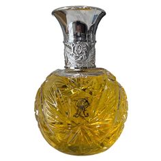 This exquisite vintage decanter combines elegance with functionality. Its intricate silver-plated cap and ornate cut crystal design make a statement piece. Displayed with amber liquid, it exudes sophistication, adding charm to any collection or space. * Silver-plated ornate cap   * Cut crystal design   * Displays amber liquid   * Vintage style   * Elegant decor piece Condition: Pre-Owned Good In very good condition, with no cracks or dings. the yellow liquid is not perfume, only filled it for aesthetic purposes. when shipping the item, the liquid will be drained. "Power Selling Mom Consignment" Ralph Lauren Safari, Vintage Decanter, Cap Cut, Vanity Storage, Crystal Design, Toiletry Storage, Store Display, Elegant Decor, Glass Containers