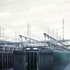 servers in a server room with wires hanging from the ceiling