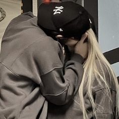 a man and woman kissing each other on the street