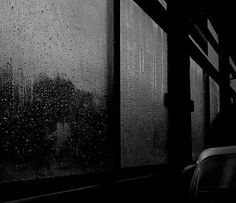 black and white photograph of rain on the window