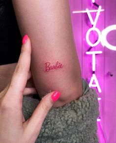 a woman's arm with the word barbie written on it