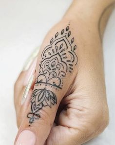 a woman's hand with a tattoo on it