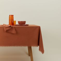 Essential cotton tablecloth in terracotta on table. Draped Backdrop, Dinner Party Table, Bath And Body Shop, Ceramic Canister, Clean Candle, Candle Holder Decor, Cotton Tablecloths, Beds For Sale, Complementary Colors