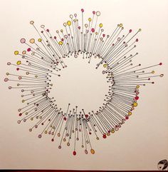 a circle made up of pins on a white background with red and yellow dots in the middle