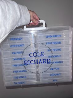 a person holding a clear plastic case with eight months on it and the words cole richard written in blue