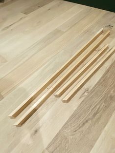 several pieces of wood sitting on top of a hard wood floor