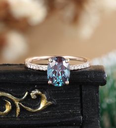 a ring with an oval blue topaz surrounded by diamonds