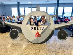 people are sitting in the cockpit of an airplane with delta on it's side