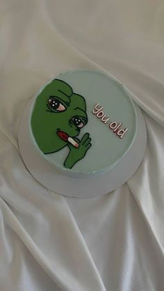 a cake with an image of a green alien on it's face and the words, you told