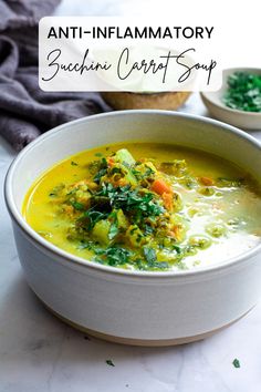 a white bowl filled with soup and topped with spinach