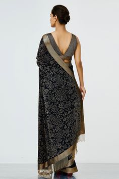 Black saree with all-over floral motif bead work, gold-tone border and tassel pallu. Comes with embellished sleeveless blouse.
Component: 2
Embroidered
Neckine: V Neck
Sleeve Length: Sleeveless
Fabric: Chiffon
Color: Black
V- back blouse
Plunging neck
Tassel pallu - Aza Fashions Elegant Brocade Pre-draped Saree For Diwali, Elegant Brocade Pre-draped Saree For Designer Wear, Elegant Festive Brocade Pre-draped Saree, Silk Anarkali Blouse Piece For Evening, Silk Anarkali Blouse For Evening, Art Silk Traditional Evening Wear With Dupatta, Traditional Evening Blouse Piece With Dupatta, Evening Anarkali Silk Blouse Piece, Gold Traditional Wear With Zari Work For Evening