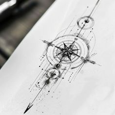 a pen drawing of a compass on paper