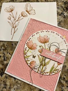 two cards with flowers on them, one is pink and the other has white paper