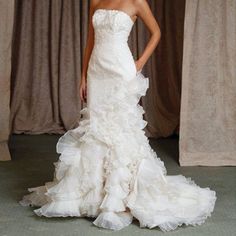 a woman in a white wedding dress posing for the camera