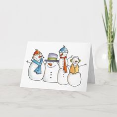 three snowmen with hats and scarves are standing in front of a white background