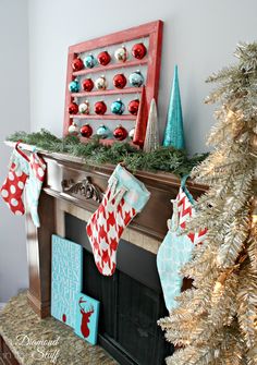 christmas stockings hung on the mantel in front of a fireplace decorated with red, white and blue ornaments