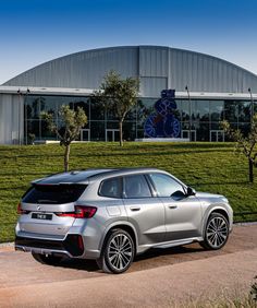 a silver suv parked in front of a building