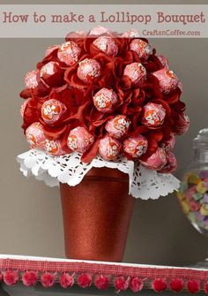 a vase filled with lots of candy sitting on top of a table next to a mirror