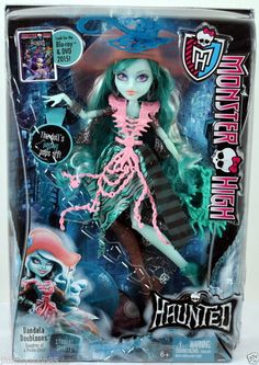 the monster doll has green hair and is wearing a black dress with pink trims