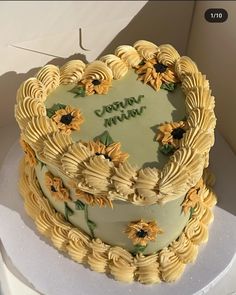 there is a cake with sunflowers on it and the words congratulations written in green