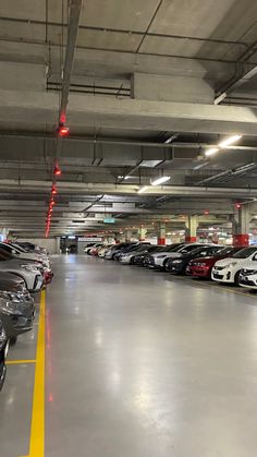 a parking garage filled with lots of parked cars