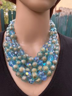 RARE FIND -  FIVE strands blue Aurora Borealis rhinestones choker/bib necklace from LISNER, circa 50's -60's. The strands are joined in TWO and THREE,  This balances the beads and insures that the beads fall evenly over the chest.  Also insures that that the beads do not get loose, because with 5 strands the necklace is rather heavy.  The blue AB beads are all multi faceted, and the silver round beads are ENCASED in a blue transparent faceted wrap.  Its an amazing item, from a by gone era... Perfect condition. Just looking for a new home.  LENGTH  17" + 2/12" extra beads - adjustable length - (photos 1 and  2) BEADS SIZE  larges diameter 1/2" - Smallest 1/2" Blue Aurora, Blue Aurora Borealis, Rhinestone Choker, Choker Necklaces, Bib Necklace, Aurora Borealis, Round Beads, Aurora, Choker Necklace