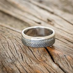 a wedding ring sitting on top of a wooden table